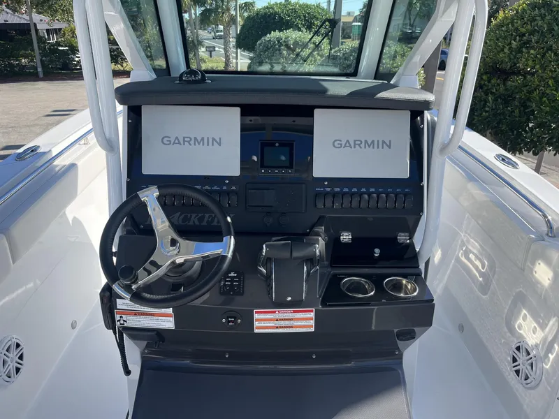 Slide: The Image of 2023 Blackfin 272 boat dashboard with dual Garmin displays and steering wheel. - 14