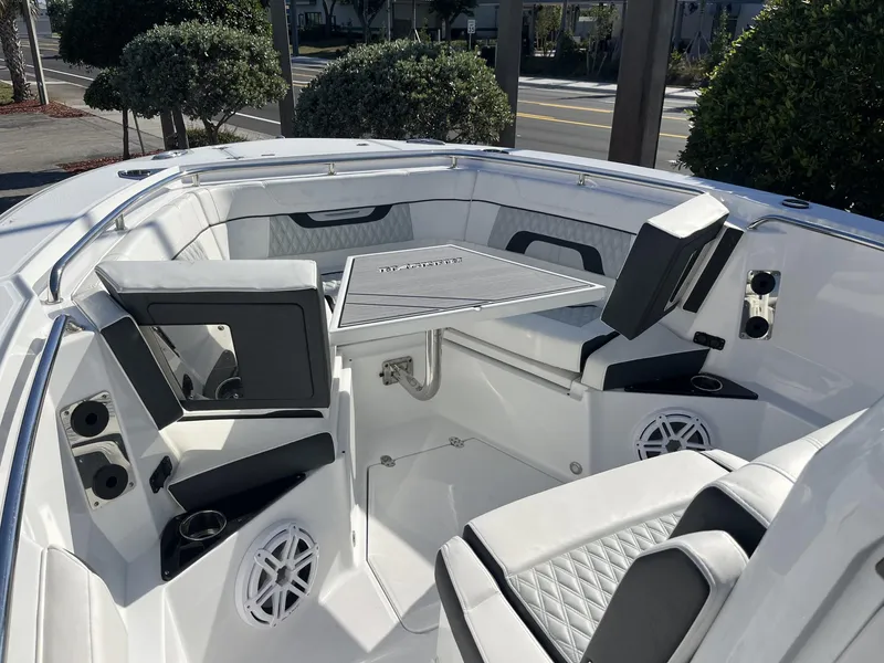 Slide: The Image of 2023 Blackfin 272 boat interior with seating and table, featuring modern design and amenities. - 21