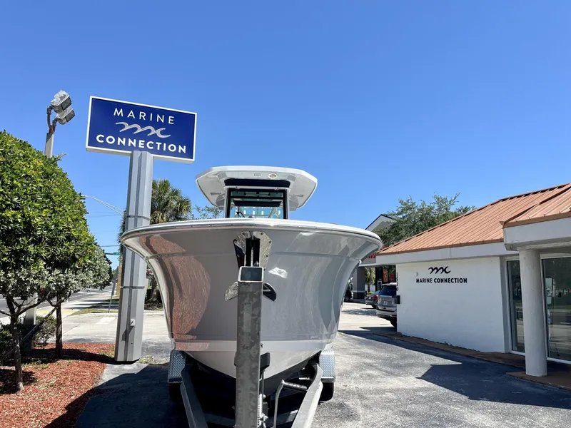 Slide: The Image of 2023 Blackfin 272 boat at Marine Connection dealership under clear blue sky. - 3