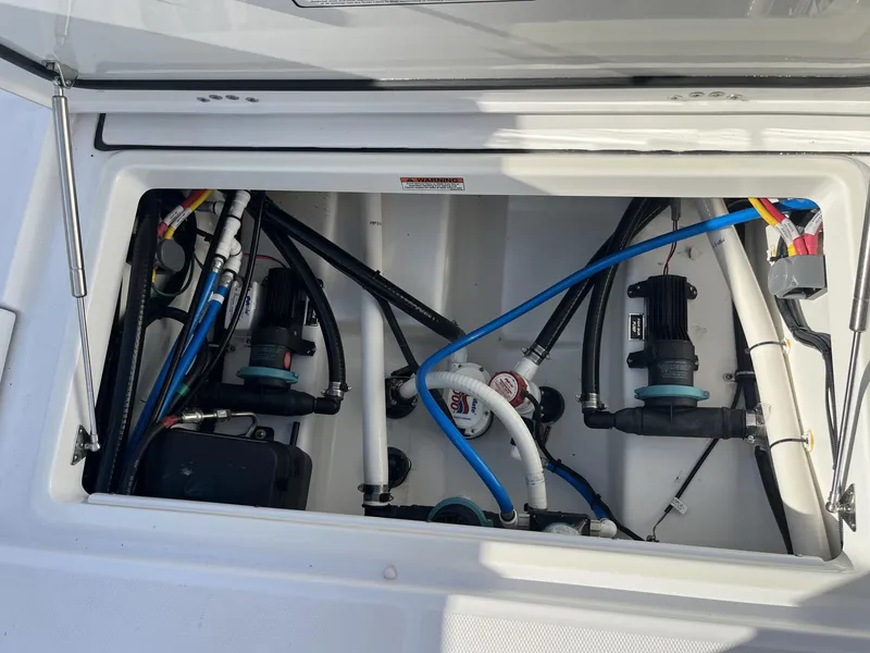 Slide: The Image of 2023 Blackfin 272 boat compartment with wiring and pumps. - 31