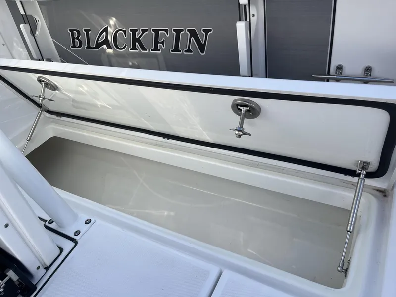Slide: The Image of 2023 Blackfin 272 boat storage compartment with open lid, showcasing interior space. - 33