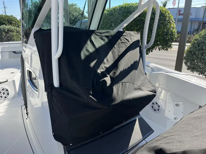 Slide: The Image of 2023 Blackfin 272 boat interior with protective cover and visible speaker. - 35
