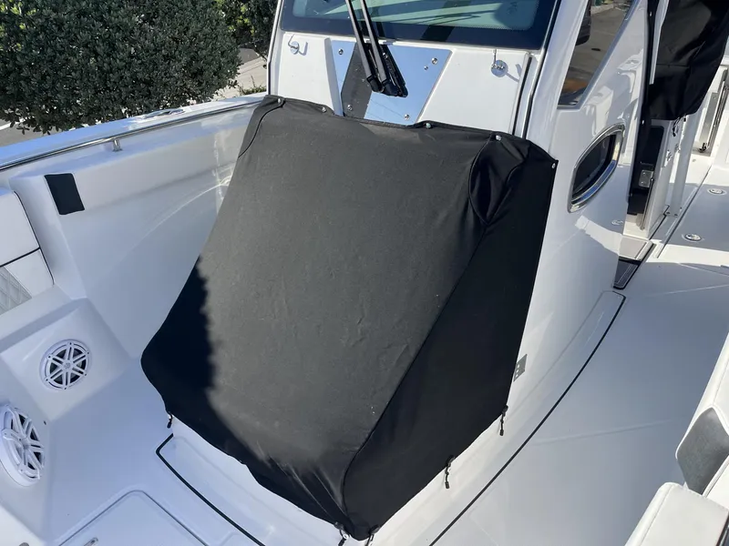 Slide: The Image of 2023 Blackfin 272 boat console with protective cover, showcasing sleek design and modern features. - 36