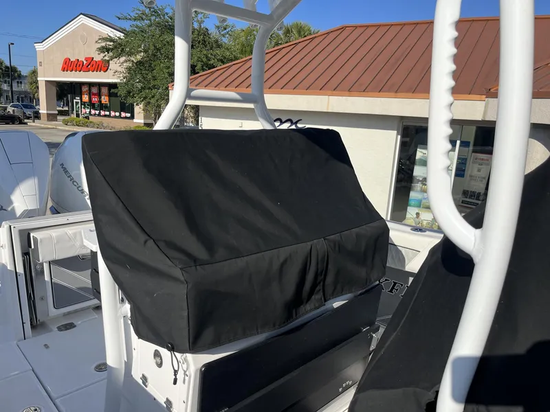 Slide: The Image of 2023 Blackfin 272 boat with covered console, parked near AutoZone store. - 37