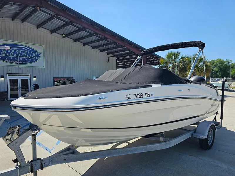 Slide: The Image of 2021 Bayliner VR5 Bowrider OB on trailer, covered, parked outside dealership. - 10