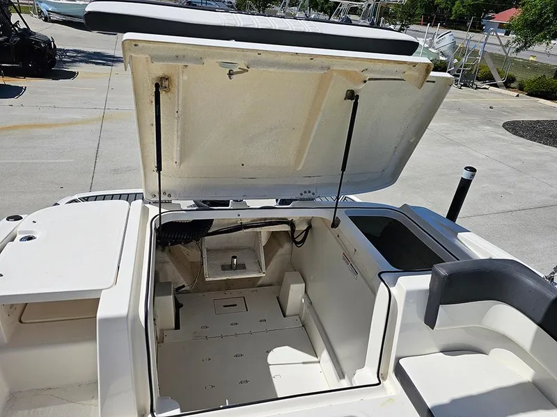 Slide: The Image of 2021 Bayliner VR5 Bowrider OB boat storage compartment open, showcasing interior space. - 15