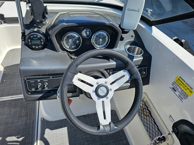 Slide: The Image of 2021 Bayliner VR5 Bowrider OB dashboard with steering wheel and Garmin device. - 22