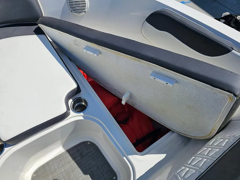 Slide: The Image of 2021 Bayliner VR5 Bowrider OB storage compartment with life jackets visible inside. - 25