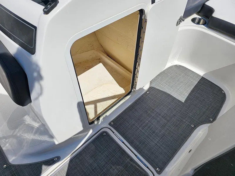 Slide: The Image of 2021 Bayliner VR5 Bowrider OB interior storage compartment with gray flooring. - 27
