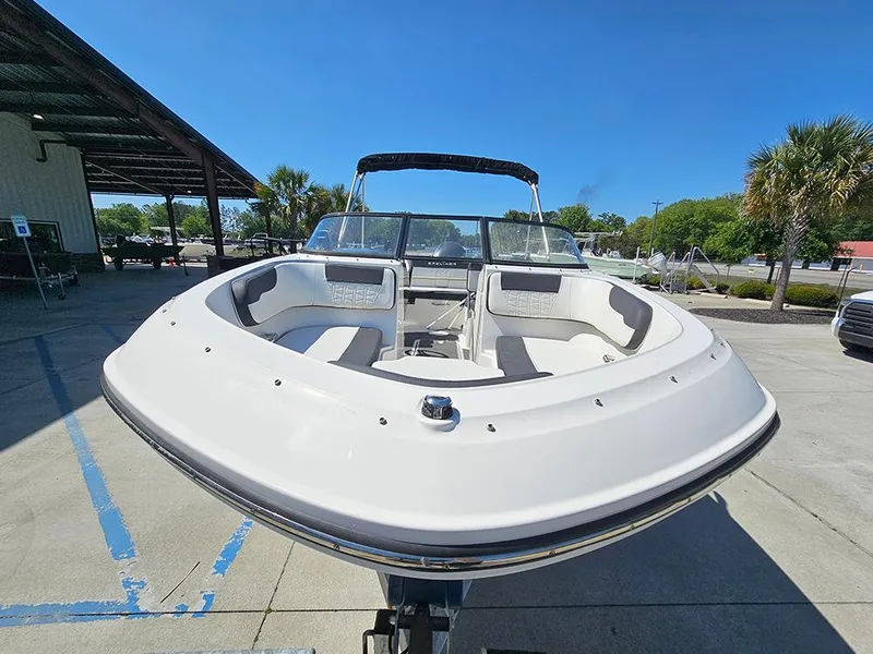 Slide: The Image of 2021 Bayliner VR5 Bowrider OB, white exterior, parked outdoors under clear blue sky. - 3