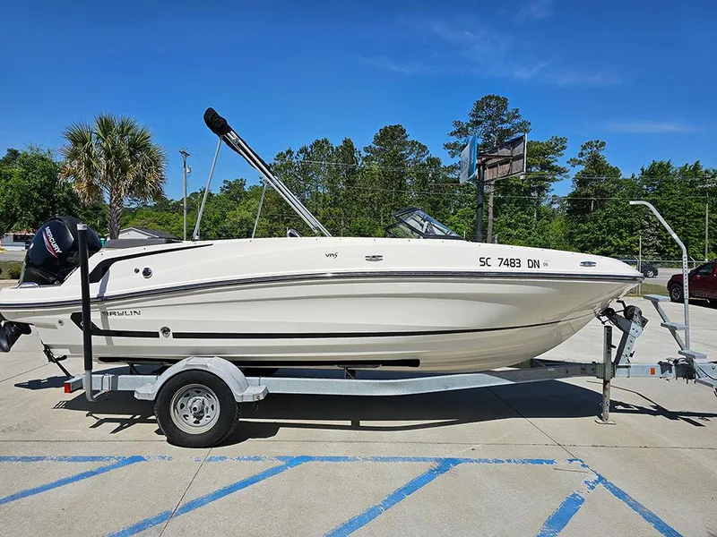 Slide: The Image of 2021 Bayliner VR5 Bowrider OB on trailer, parked outdoors under clear blue sky. - 5