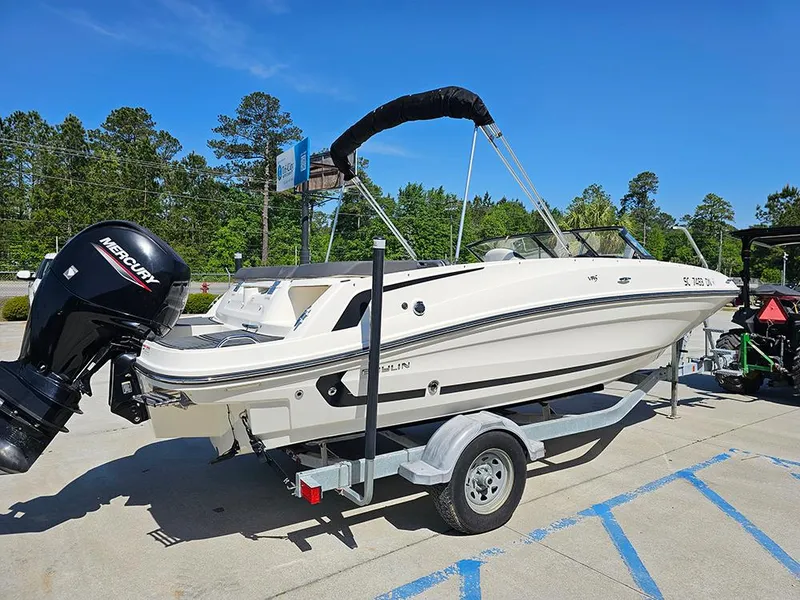 Slide: The Image of 2021 Bayliner VR5 Bowrider OB on trailer, parked outdoors under clear blue sky. - 6
