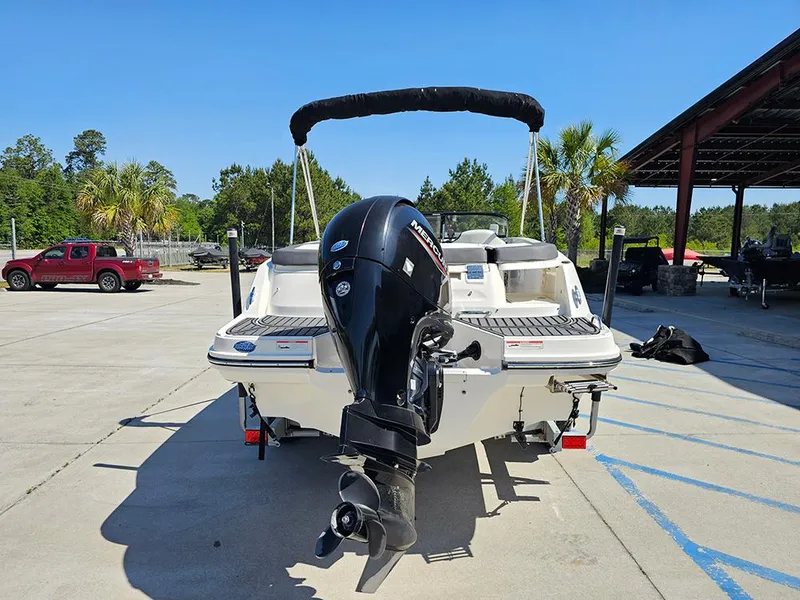 Slide: The Image of 2021 Bayliner VR5 Bowrider OB with outboard motor, parked outdoors on a sunny day. - 8