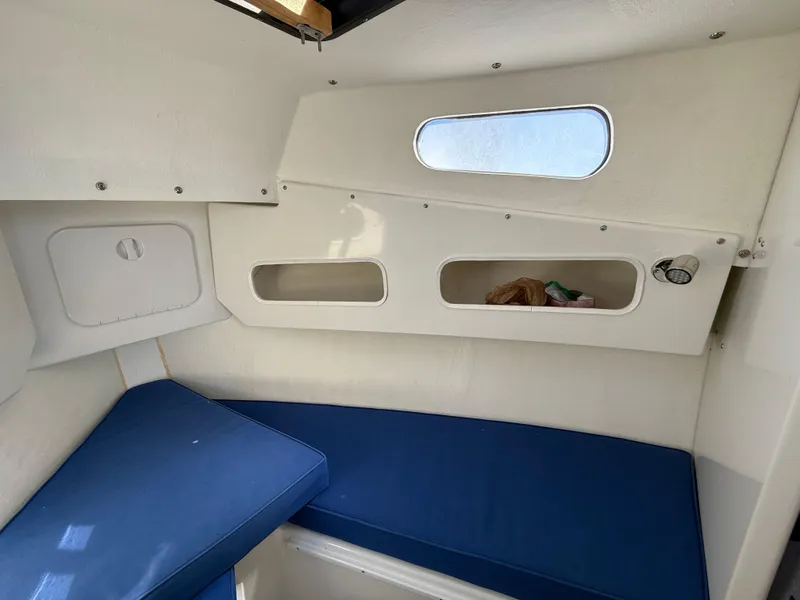 Slide: The Image of 2018 Rosborough 246 Yarmouth boat interior with blue cushions and storage compartments. - 15