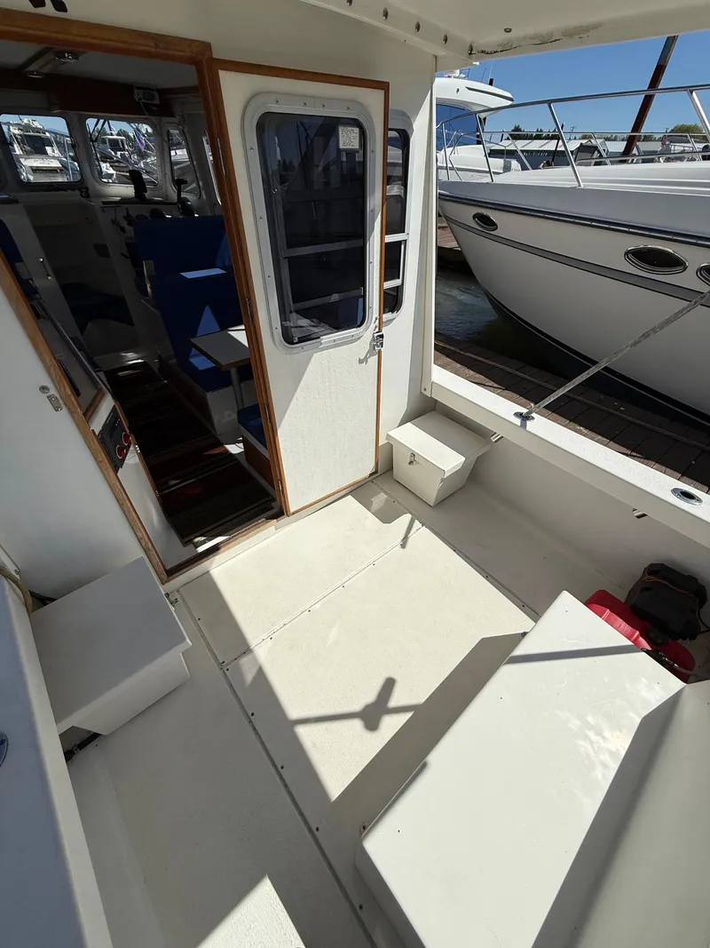 Slide: The Image of 2018 Rosborough 246 Yarmouth boat interior, featuring seating and access to cabin. - 7