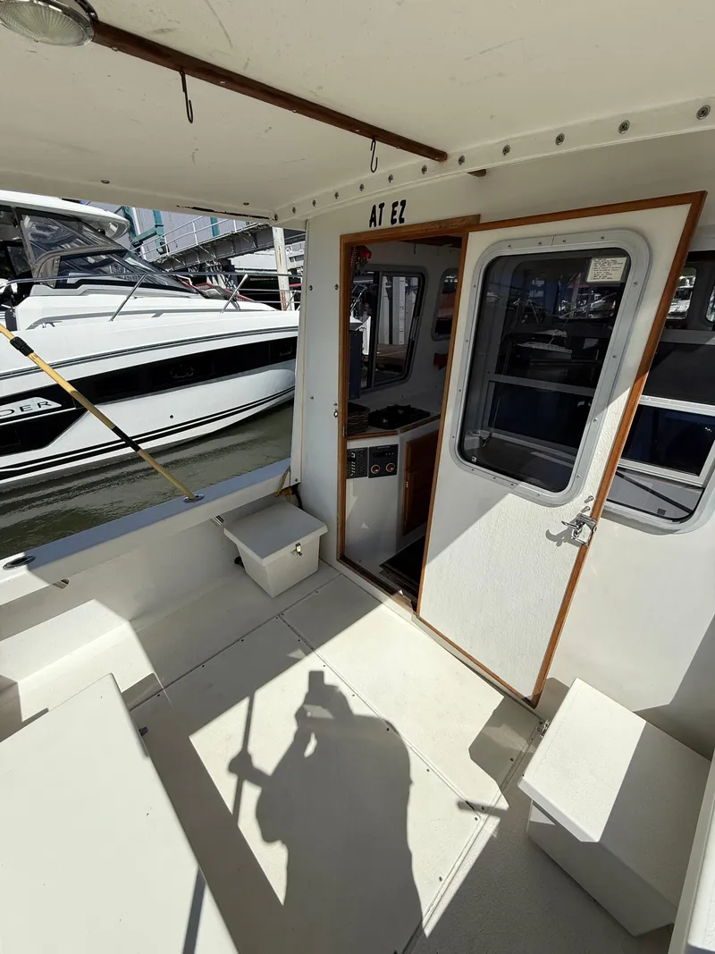 Slide: The Image of 2018 Rosborough 246 Yarmouth boat interior with docked vessel in background. - 8