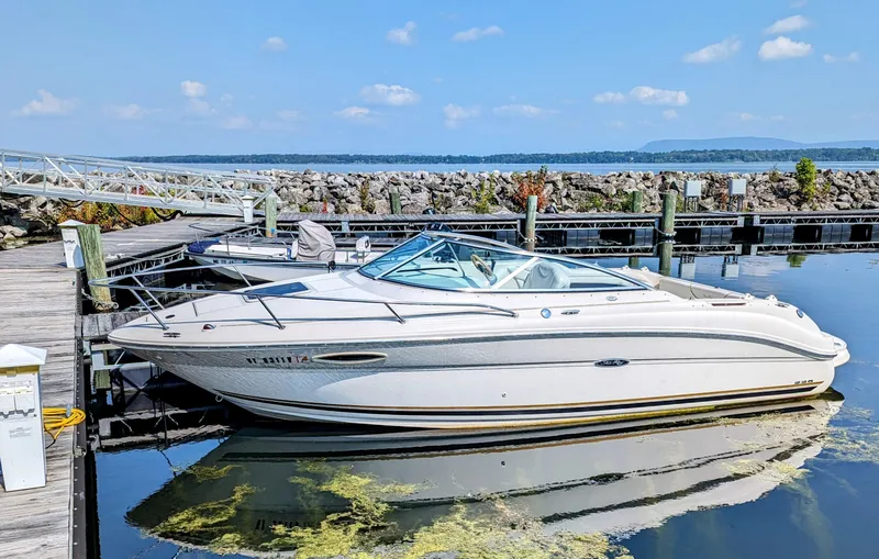 Slide: The Image of 2001 Sea Ray 225 Weekender boat docked at a marina on a sunny day. - 2