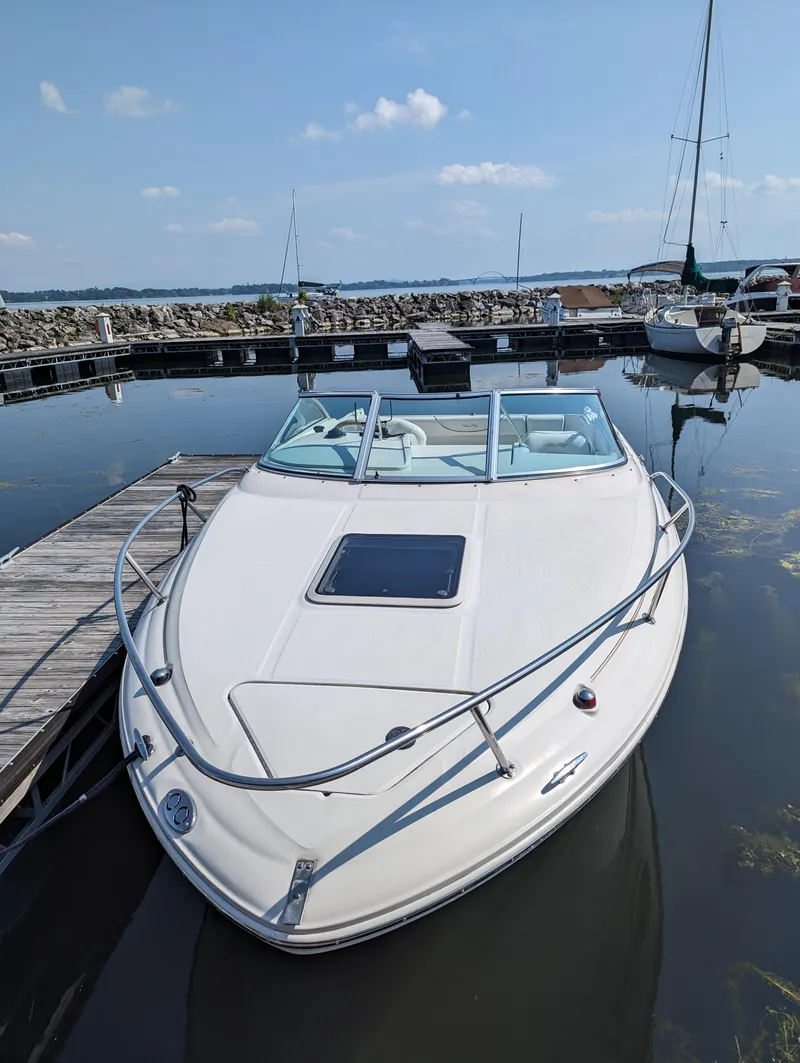 Slide: The Image of 2001 Sea Ray 225 Weekender boat docked at marina under clear blue sky. - 6