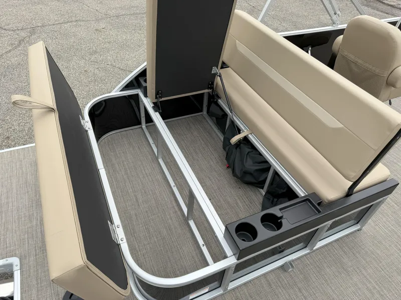 Slide: The Image of 2025 Godfrey EX2086SFLX pontoon boat interior with beige seating and storage compartments. - 10