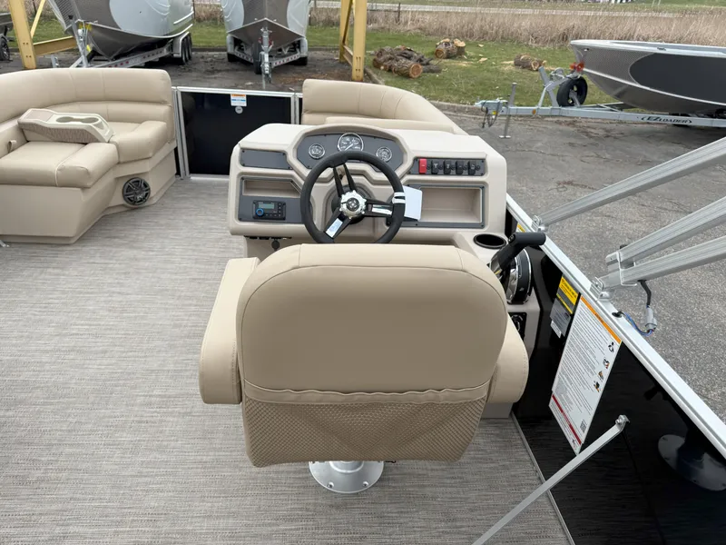 Slide: The Image of 2025 Godfrey EX2086SFLX boat interior with beige seating and steering console. - 12