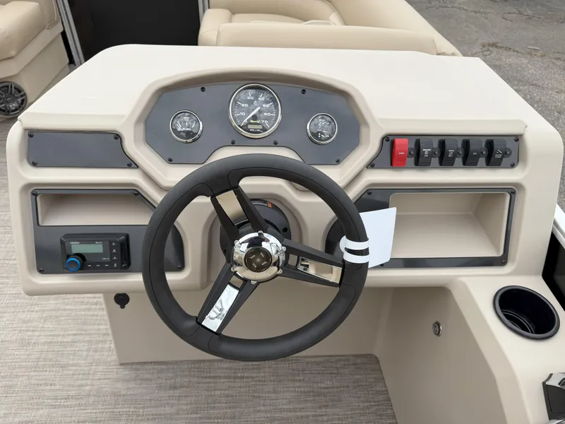 Slide: The Image of Steering console of 2025 Godfrey EX2086SFLX boat with gauges and controls. - 13