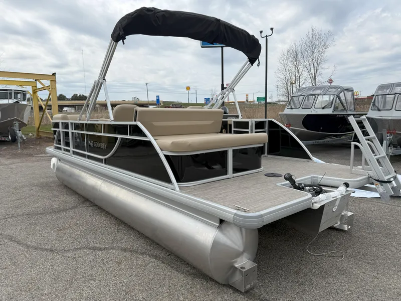 Slide: The Image of 2025 Godfrey EX2086SFLX pontoon boat with canopy, parked on asphalt. - 7
