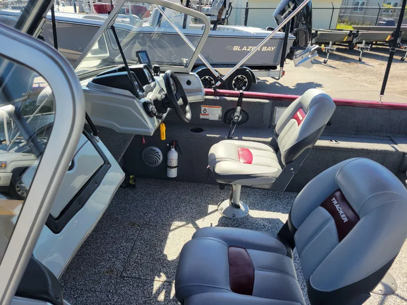 Slide: The Image of 2016 Tracker Pro Guide V-175 Combo boat interior with seating and steering console. - 11