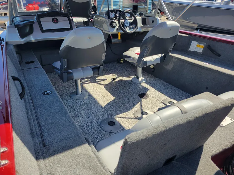 Slide: The Image of 2016 Tracker Pro Guide V-175 Combo boat interior with seating and steering console. - 13