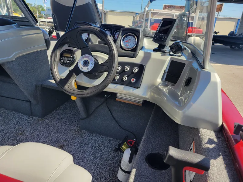 Slide: The Image of 2016 Tracker Pro Guide V-175 Combo boat dashboard with steering wheel and controls. - 16