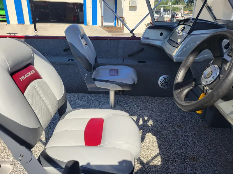 Slide: The Image of 2016 Tracker Pro Guide V-175 Combo boat interior with seating and steering wheel. - 17