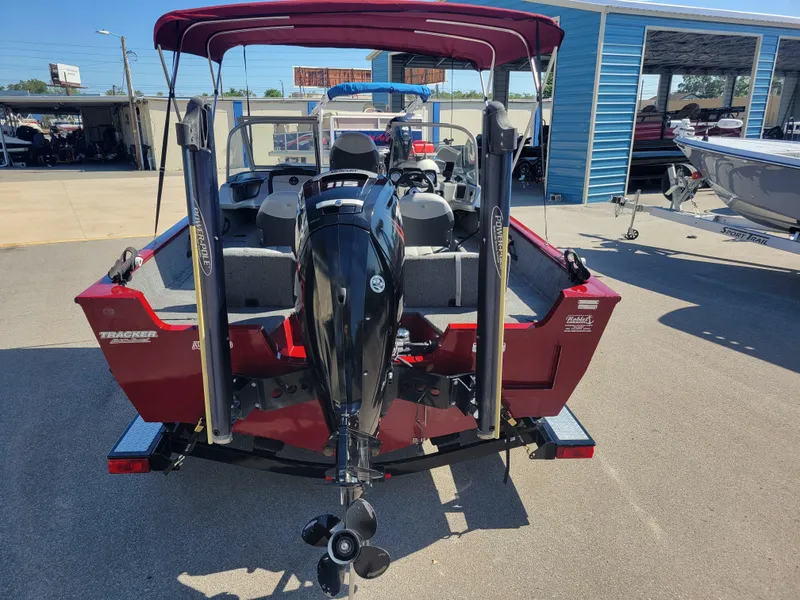 Slide: The Image of 2016 Tracker Pro Guide V-175 Combo boat, rear view, with outboard motor and red canopy. - 6
