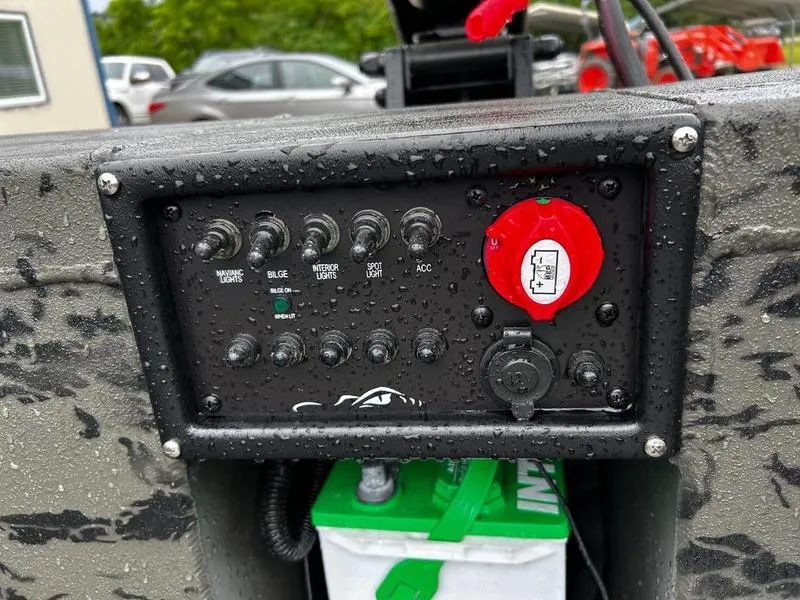 Slide: The Image of Control panel of 2025 Gator Tail 1860 Extreme Mod V boat, featuring switches and battery compartment. - 10