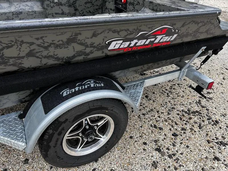 Slide: The Image of 2025 Gator Tail 1860 Extreme Mod V boat on trailer, featuring rugged design and logo. - 12