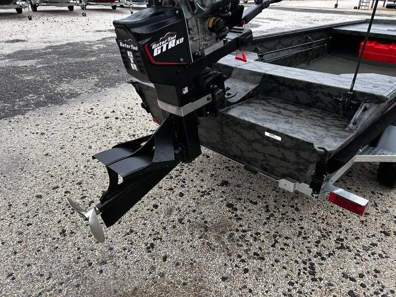 Slide: The Image of 2025 Gator Tail 1860 Extreme Mod V boat with powerful outboard motor on a trailer. - 7