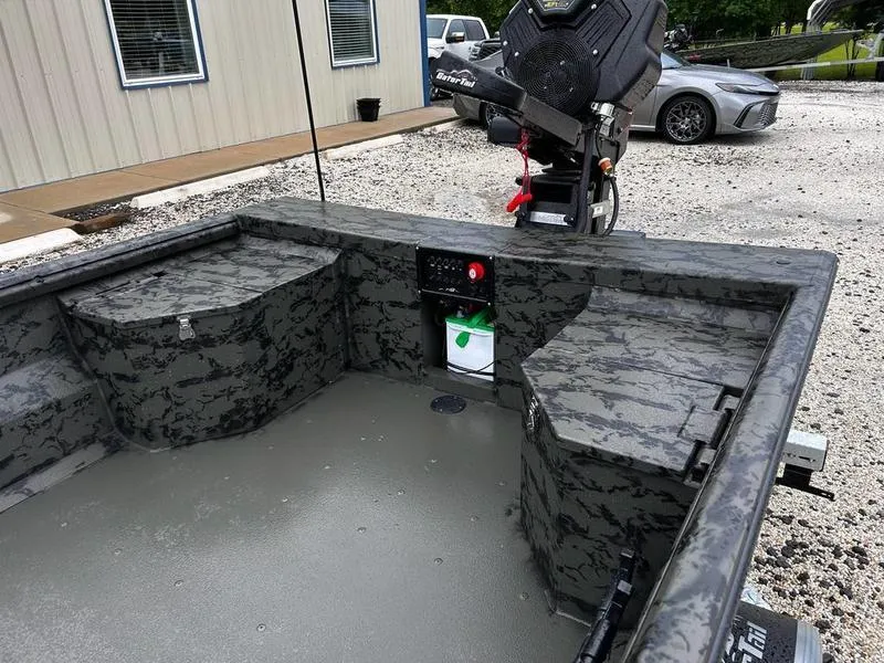 Slide: The Image of 2025 Gator Tail 1860 Extreme Mod V boat interior with camouflage design and storage compartments. - 8
