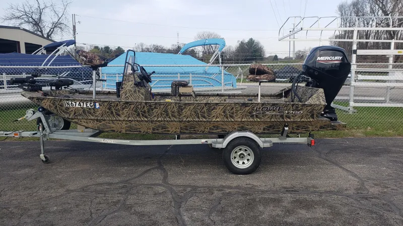 Slide: The Image of 2021 Lowe RTX1760PT camouflage boat on trailer with Mercury outboard motor. - 1
