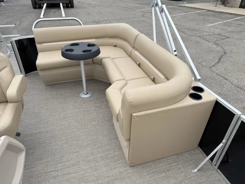 Slide: The Image of Luxurious seating area on 2025 Godfrey EX2086CX pontoon boat with beige upholstery and cup holders. - 11