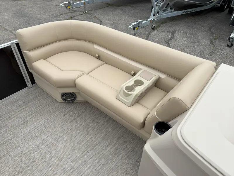 Slide: The Image of Luxurious beige seating on 2025 Godfrey EX2086CX boat with cup holders and speaker. - 12