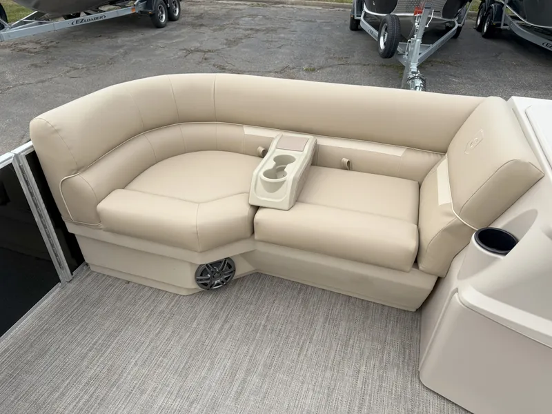 Slide: The Image of Luxurious beige seating on 2025 Godfrey EX2086CX boat with cup holders and speaker. - 14