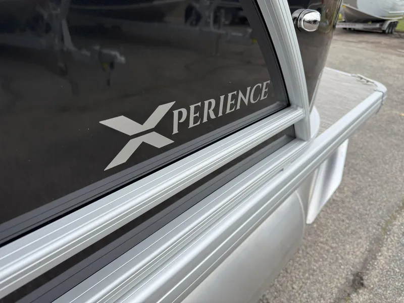 Slide: The Image of 2025 Godfrey EX2086CX Xperience boat, close-up of logo and sleek design. - 17