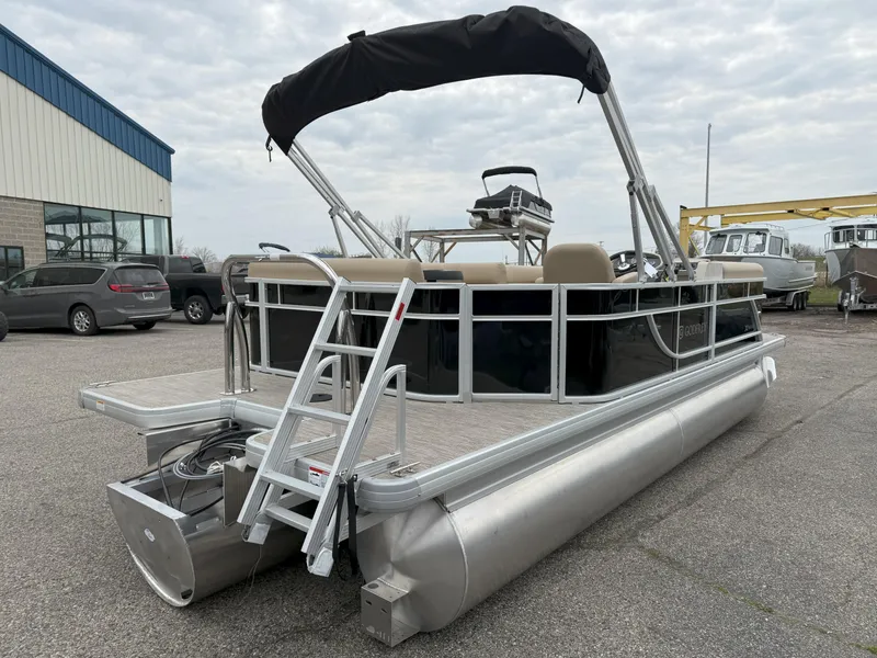 Slide: The Image of 2025 Godfrey EX2086CX pontoon boat with canopy, parked outdoors. - 4