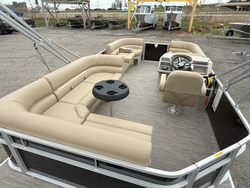 Slide: The Image of 2025 Godfrey EX2086CX pontoon boat with beige seating and steering console. - 7