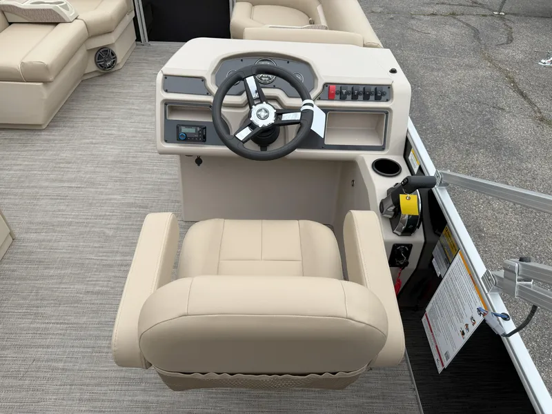 Slide: The Image of 2025 Godfrey EX2086CX boat helm with beige captain's chair and modern steering console. - 9