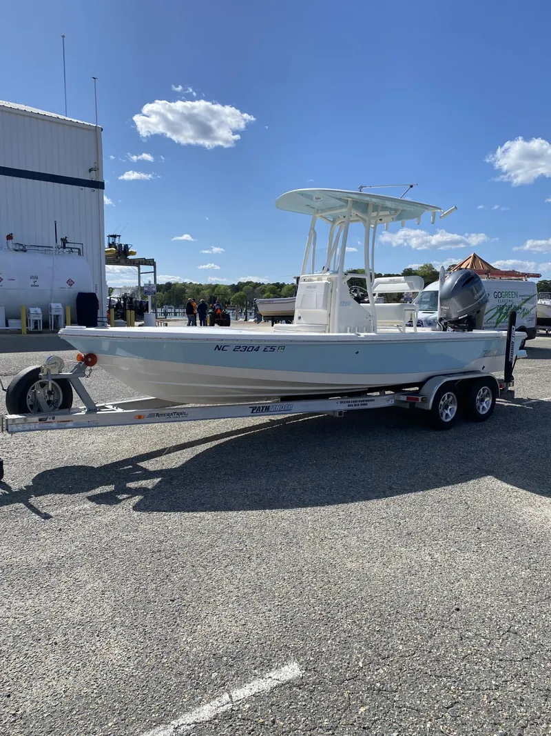 Slide: The Image of 2021 Pathfinder 2200 TRS boat on trailer in sunny outdoor setting. - 2