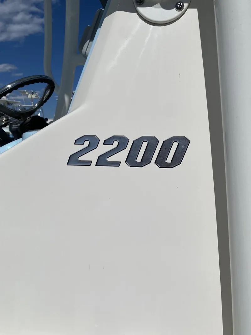 Slide: The Image of Close-up of 2021 Pathfinder 2200 TRS boat model emblem on white surface. - 3