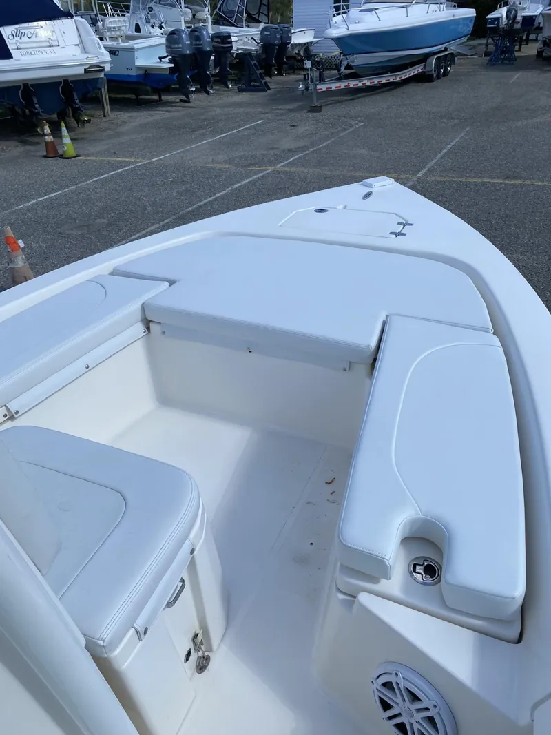Slide: The Image of 2021 Pathfinder 2200 TRS boat interior with white seating and storage compartments. - 5