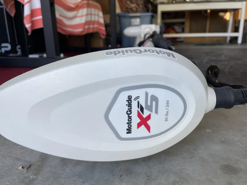 Slide: The Image of Trolling motor head with MotorGuide X5 logo, 80 lbs thrust, in a garage setting. - 9