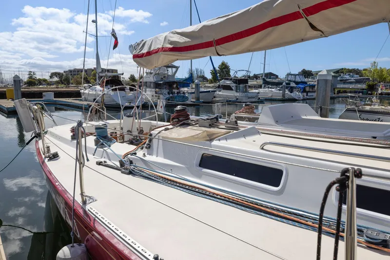 Slide: The Image of Sailboat J/130 from 1994 docked at marina, featuring sleek design and rigging. - 11