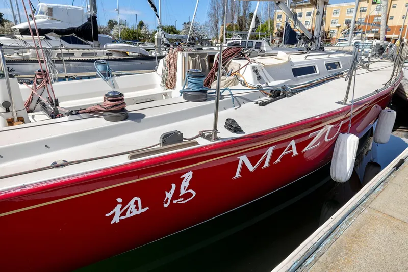 Slide: The Image of Red 1994 J Boats J/130 sailboat docked in marina, side view. - 12