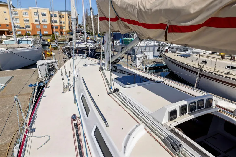 Slide: The Image of Sailboat J/130 from 1994 docked at marina, showcasing deck and rigging. - 13